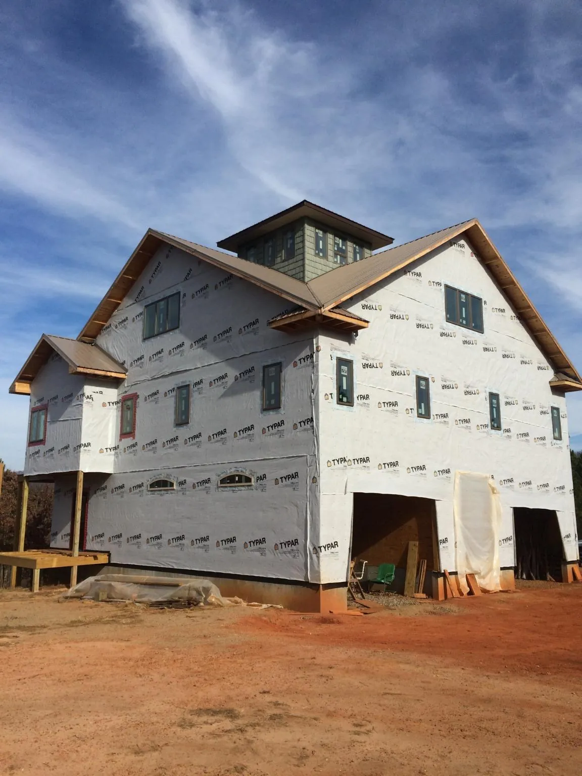 New two story house under construction with a cupola and gabled roofs in Paisley